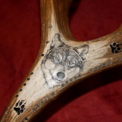 wolf scrimshaw on antler cribbage board