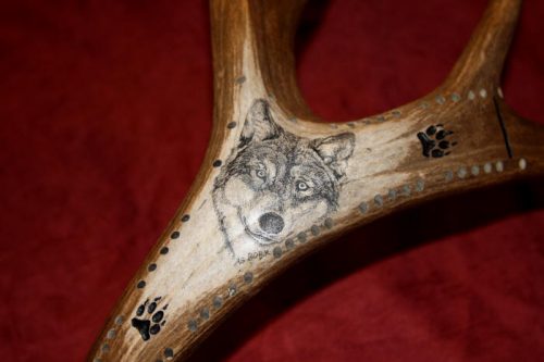 wolf scrimshaw on antler cribbage board