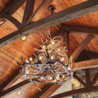 Holland Peak Large trophy elk and mule deer antler chandelier in a rustic great room