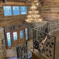 Rustic mountain home with 4 tier whitetail antler chandelier in entryway