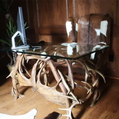 Custom-built artisan desk featuring natural North American elk antler accents and a rustic wooden desktop.
