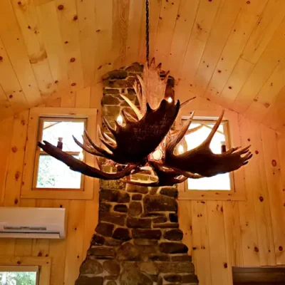 McHugh Peak moose antler chandelier in a rustic lodge dining room